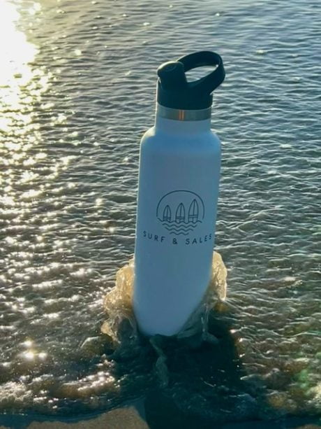 surf and sales water bottle on the beach