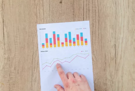 hand-pointing-to-graph-on-a-piece-of-paper