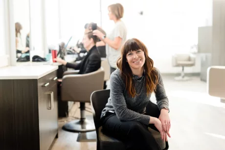 woman-in-an-office-chair-smiling-at-camera