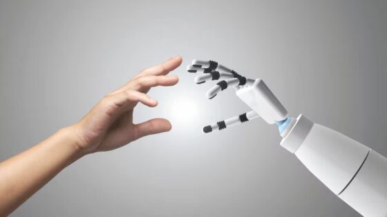 a human hand reaching out towards a robot hand