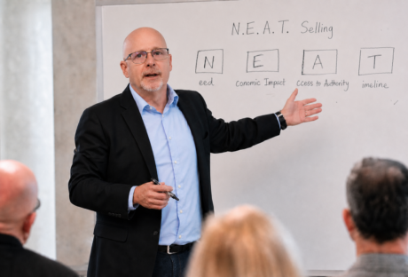 Richard Harris explaining N.E.A.T. Selling during a customized sales training session