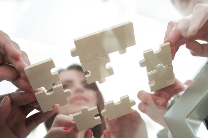 bottom view. business team folding puzzle pieces