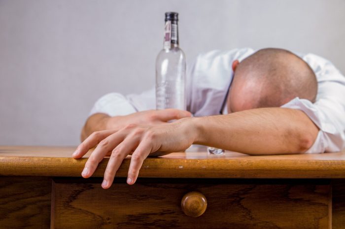 man holding an empty bottle