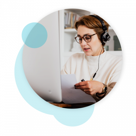 women wearing headphones working on her computer