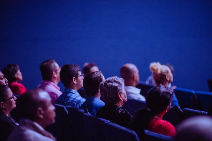 people sitting in audience of an event