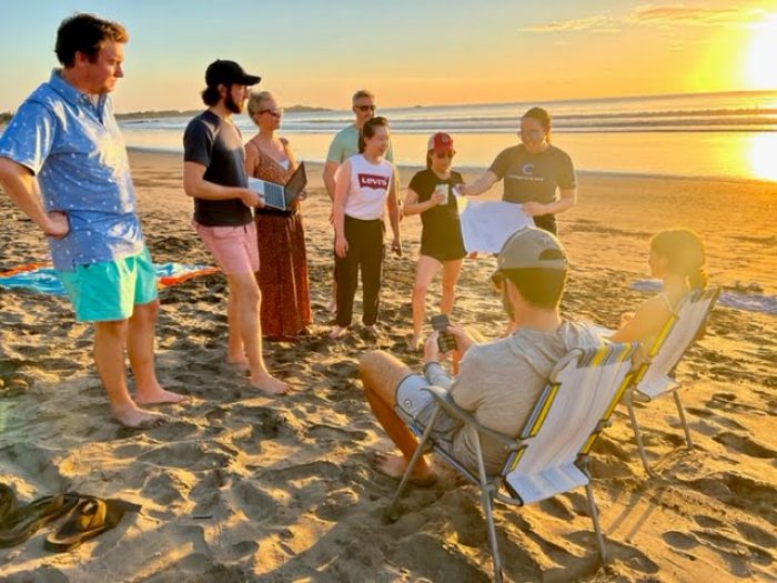 surf and sales crew on the beach