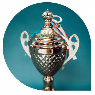 silver trophy with ribbon on it