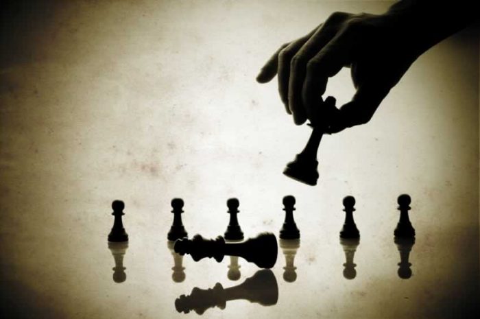 person making a move in chess
